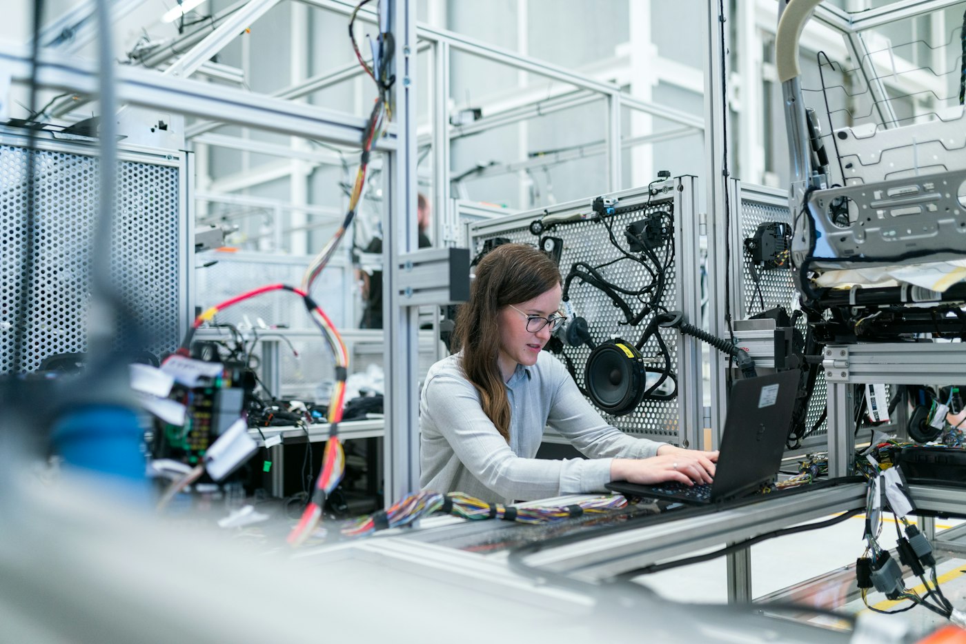 Engineer in an industrial setting near sensors and metering equipment